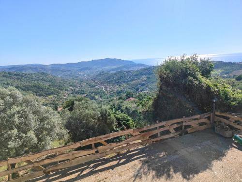 a wooden bench sitting on top of a hill at A casa di zia in Agropoli