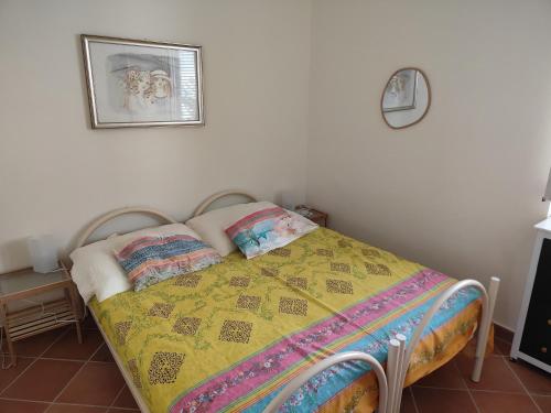 a bed with a quilt on it in a bedroom at A casa di zia in Agropoli