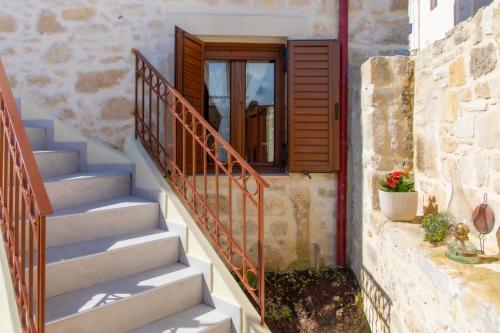 a set of stairs leading up to a door at Asmani in Kato Asites