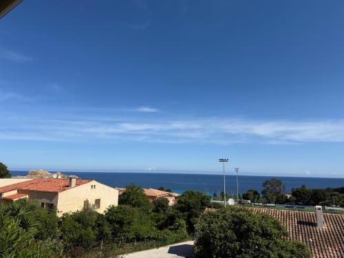 a view of the ocean from a house at Location du Ranch in Algajola