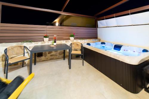 a kitchen with a table and a bath tub at Asmani in Kato Asites