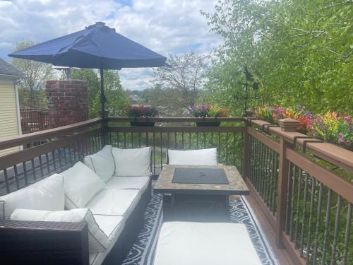a patio with a couch and a table with an umbrella at Salem's Enchanted Inn in Salem