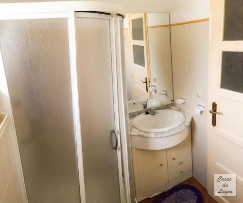 a bathroom with a sink and a mirror at Casas Da Lagoa - T2 Norte in Aldeia de Brescos