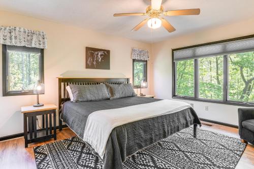 a bedroom with a bed with a ceiling fan and windows at 4 Mi to Massanutten Resort Family Home with Views! in McGaheysville