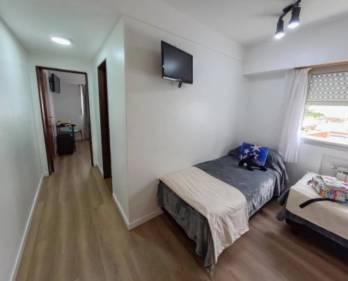 a bedroom with a bed and a tv on the wall at Hotel Solmar in San Clemente del Tuyú