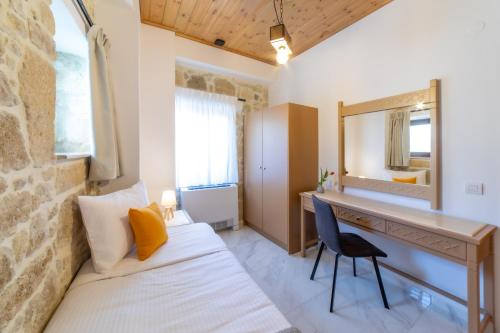 a bedroom with a desk and a mirror and a bed at Asmani in Kato Asites