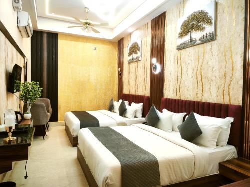 a hotel room with two beds in a room at Shri Shyam Luxury Hotel in Har Ki Paudi in Haridwār