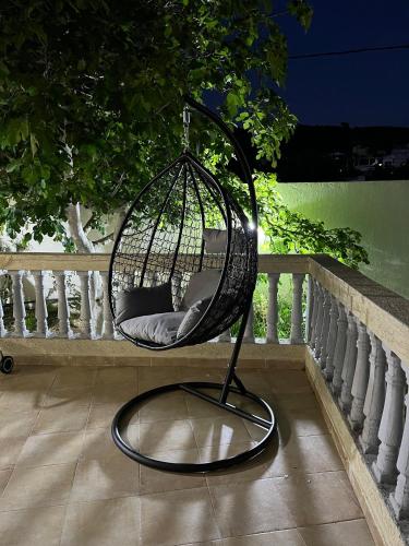 a bird cage sitting on top of a porch at Villa a oued alien in Tangier