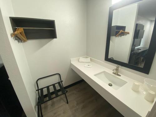 a white bathroom with a sink and a mirror at Motel 6-Windsor Locks, CT - Hartford in Windsor Locks