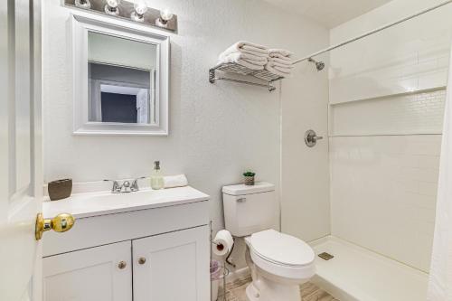 a white bathroom with a toilet and a shower at 5 Mi to Las Vegas Strip Condo with Community Perks! in Las Vegas
