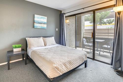 a bedroom with a bed and a balcony with a table at 5 Mi to Las Vegas Strip Condo with Community Perks! in Las Vegas