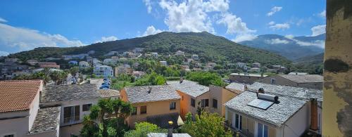 a view of a city with houses and a mountain at Casa Sanna, T2 waterfront Miomo, Cap Corse in Santa-Maria-di-Lota