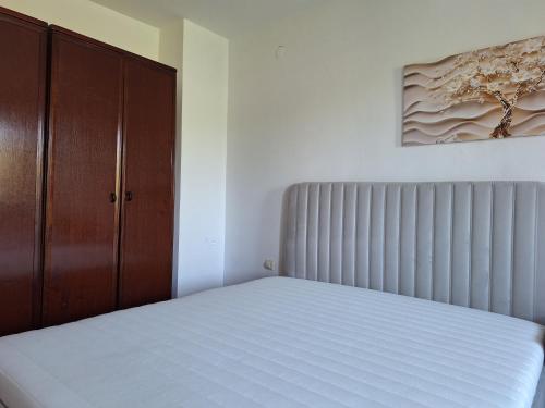 a bedroom with a bed and a radiator at RIVIJERA GREEN in Belgrade