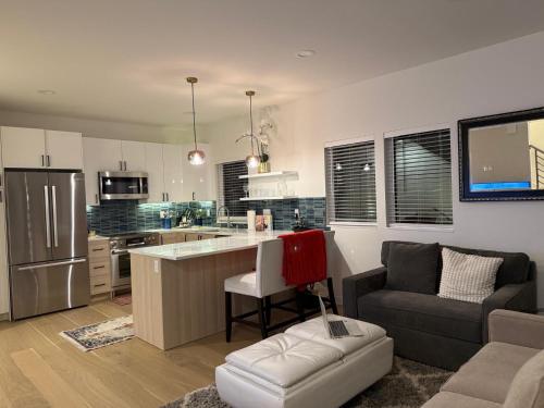 a kitchen and living room with a couch and a table at Alki Beach Front TownHome in Seattle