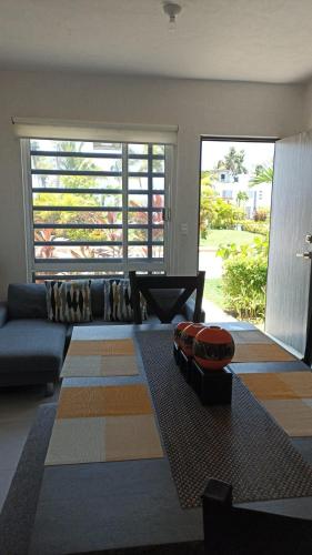 a living room with a couch and a large window at Casa Acapulco de mis amores Diamante in Icacos