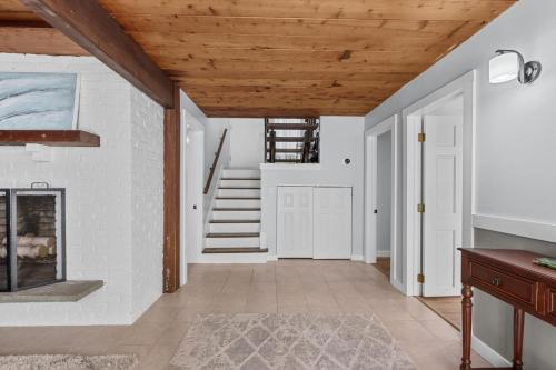 a hallway with white walls and wooden ceilings at 10 Bunker Circle Sandwich - The Clubhouse Retreat in Sandwich