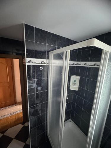a shower with a glass door in a bathroom at Zidanica Jakec in Podlehnik