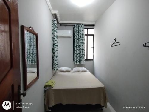 a small bedroom with a bed and a window at Duque HOSTEL in Belém