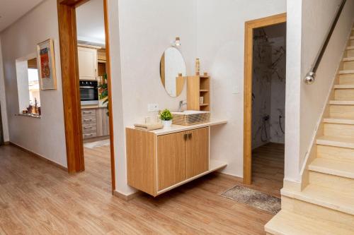 a hallway with a vanity and a mirror and stairs at Peaceful Family Villa on a Farm with Private Pool and Stunning Mountain Views in Agadir
