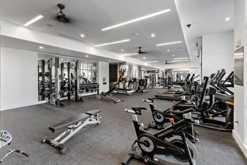 a gym with a bunch of treadmills and machines at LUXE 1BD - 5 Min DT, Gym, Parking, W-D - Sleeps 6 in Charlotte