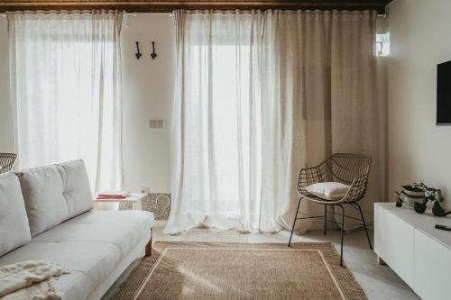 a living room with a couch and a chair at Abrigos do Castelo in Carvalho de Rei
