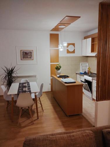 a kitchen with a table and a dining room at Apartment Bella Vista in Kravlja