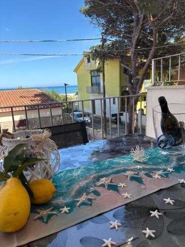 a table with lemons and a bottle of wine on it at all ombra dei pini in La Caletta