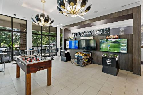 a game room with a foosball table and video games at Spacious 2BD - 5 Min DT, Gym, Parking, W-D - Sleep 12 in Charlotte