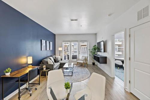 a living room with a couch and a table at Beautiful 1BD - 5Min DT, Gym, Parking, W-D - Sleeps 6 in Charlotte