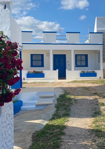 a white house with blue doors and a driveway at The Retreat - Ria Formosa Hamlet in Moncarapacho