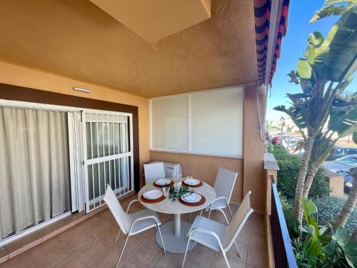 a patio with a table and chairs on a balcony at Beachside Vacation Apartment in Casares Playa in San Luis de Sabinillas