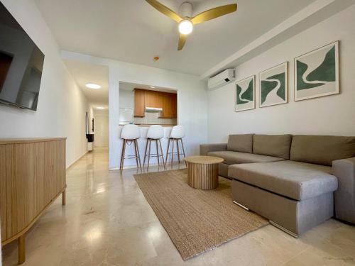 a living room with a couch and a kitchen at Beachside Vacation Apartment in Casares Playa in San Luis de Sabinillas