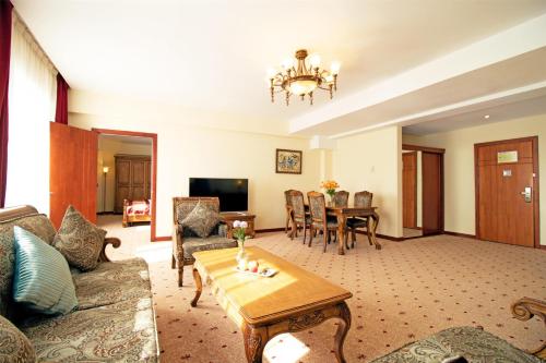 a living room with a couch and a table at Kempinski Hotel Khan Palace in Ulaanbaatar