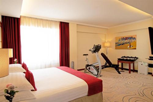 a hotel room with a bed and a desk at Kempinski Hotel Khan Palace in Ulaanbaatar