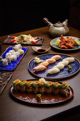 a wooden table with plates of food on it at Kempinski Hotel Khan Palace in Ulaanbaatar