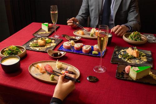a table with plates of food and glasses of wine at Kempinski Hotel Khan Palace in Ulaanbaatar