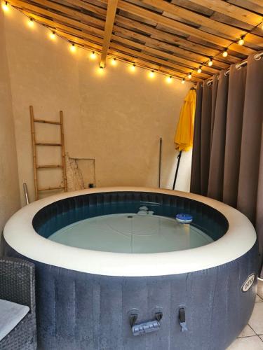 a hot tub in a room with lights on it at La citadelle in Nyons