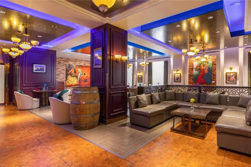 a bar with couches and a barrel in a room at Kempinski Hotel Khan Palace in Ulaanbaatar