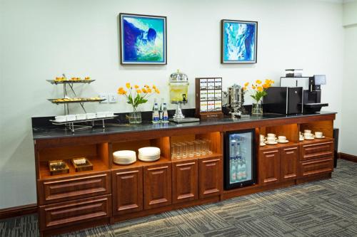 a display cabinet with dishes and flowers on it at Kempinski Hotel Khan Palace in Ulaanbaatar