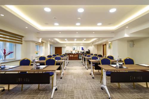 a conference room with tables and chairs and a podium at Kempinski Hotel Khan Palace in Ulaanbaatar