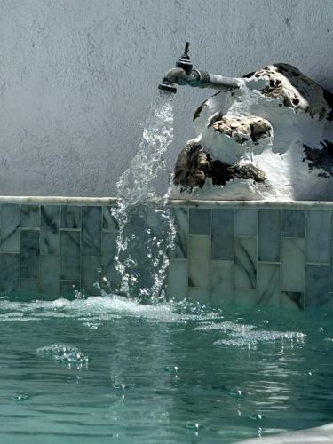 a water fountain in the middle of a pool of water at Mouradia Safara in Safara