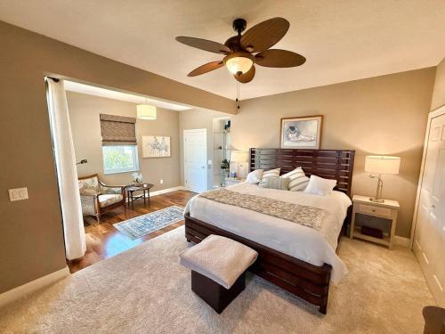 a bedroom with a bed and a ceiling fan at The Salty Pelican Flagler Beach in Flagler Beach