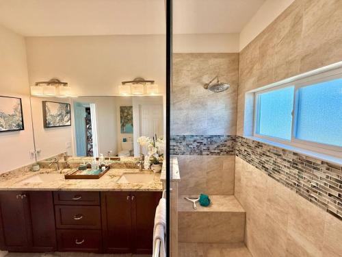 a bathroom with a sink and a mirror at The Salty Pelican Flagler Beach in Flagler Beach