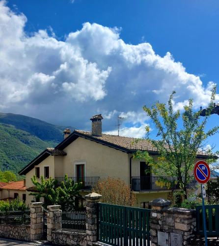 a house with a fence in front of it at A due passi dai lupi in Civitella Alfedena