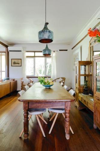 a dining room with a table with a bowl of fruit on it at The Farmhouse, elegance in the Margaret River coastal countryside in Rosa Brook