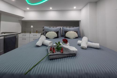 a bedroom with a large bed with towels and flowers on it at Matija Lux2 in Kraljevo