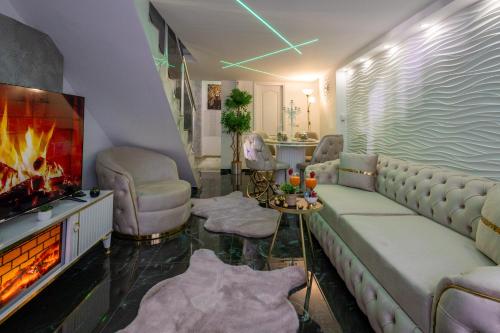 a living room with a couch and a fireplace at Matija Lux2 in Kraljevo