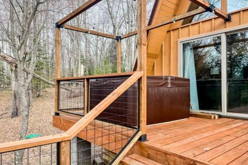 a house with a chicken cage on a deck at Tamarack Lodge Tomahawk WI in Lake Tomahawk