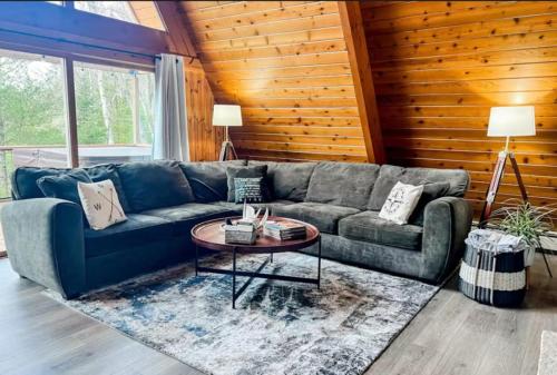 a living room with a couch and a table at Tamarack Lodge Tomahawk WI in Lake Tomahawk