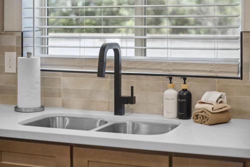 a kitchen counter with a sink and a window at Boho on Bermuda By Rather Be Properties in Tucson